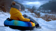 © Laura - Faceless child resting on a snow tube at the bottom of the hill, softly blurred surroundings creating calm winter mood, with copy space