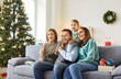 © Studio Romantic - Happy family with kids enjoying leisure time together on the sofa at home living room during Christmas or New Year. Fun holiday atmosphere, where the family bonds and enjoys time together.