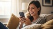 © Bounpaseuth - Joyful Connection: A woman glows with happiness while absorbed in her phone, sharing smiles and joy
