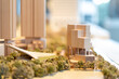 © Em Neems Photography - Wooden cityscape architectural model features buildings, waterfront, trees, urban planning concept