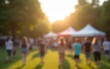 © nian - Blur background event at park fair nature scene people engaging bright daytime activity. High quality