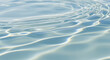 © TYAK_FACTORY - Close-up of clear pale blue water ripples reflecting bright sunlight