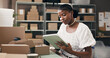 © peopleimages.com - Black woman, tablet and boxes for dropshipping, logistics or supply chain with scroll for distribution schedule. Person, tech and review with package, app or notes for inventory management at startup