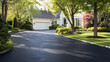 © Naufal - Freshly paved asphalt driveway in front of a suburban white house, clean and smooth surface symbolizing home improvement, residential construction, real estate, and modern neighborhood living.