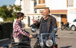 © Antonio Recena - Grandfather and grandson: The 60-year-old man finally parks his motorcycle and talks to his grandson after taking a ride