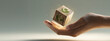 © heerim studio - Caring for Earth: Hand holds wooden cube with ecology symbols floating.