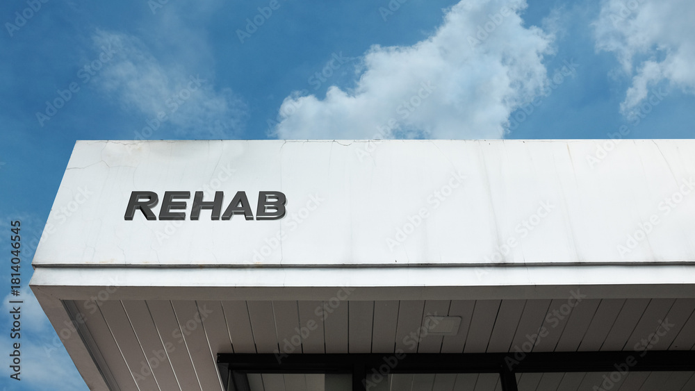 Recoevry Signage Rehab word signage on a medical or treatment building under a blue sky ...