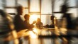 © World Images - Dynamic business meeting with a radial blur effect showing a silhouetted team in a sunlit office.