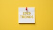 © Husen - A white sticky note with the text '2026 Trends' pinned with a red thumbtack on a yellow background.