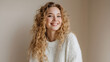 © utaem2022 - Young woman with natural curly blonde hair smiling