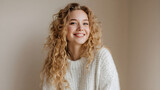 Young woman with natural curly blonde hair smiling