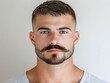 © Sam - A young Caucasian man with striking blue eyes and a well-groomed mustache poses confidently against a neutral background.