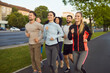 © Studio Romantic - Runners group jogging through park, team training together on track in summer morning. Smiling young fit people run marathon for endurance and motivation training, enjoying healthy outdoors exercise