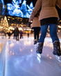 © Milos - Young skaters glide across a beautifully illuminated ice rink, underscored by twinkling holiday lights, creating delightful winter memories to cherish and share with loved ones.