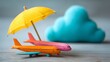© Tanvir - colorful aeroplane rests beside cheerful cloud and bright umbrella, symbolizing importance of insurance for travel safety.