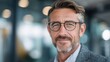 © Johannes - confident middleaged businessman with glasses smiling in modern office setting showcasing professionalism and success in corporate environment
