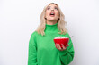 © luismolinero - Young Russian woman holding a bowl of cereals isolated on white background looking up and with surprised expression