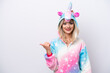 © luismolinero - Young Russian woman with unicorn pajamas isolated on white background pointing to the side to present a product