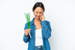 © luismolinero - Young hispanic woman holding chive isolated on white background frustrated and covering ears