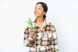 © luismolinero - Young hispanic woman holding a green beans isolated on white background thinking an idea pointing the finger up