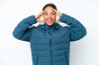 © luismolinero - Young hispanic woman wearing a winter earmuffs isolated on white background with surprise expression