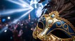 © Bevan - Elegant blue and gold masquerade mask with feathers, sharply focused against a blurred background of a lively party scene with shimmering lights, evoking mystery and celebration