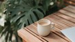 © CYBERPINK - Wooden table with a white mug on it. the mug is filled with a light-colored liquid, possibly coffee or tea. next to the mug, there is a silver laptop.