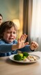 © Margarita Ratatosk - Crying boy refusing to eat healthy food. Childhood struggle with picky eating and food aversion, parenting challenges for neurodiverse kid.