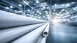 © Jojo* - White PVC plastic pipes stacked in a large industrial warehouse background.