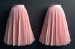 © Pete - Two pastel pink pleated skirts on dark grey background. Soft fabric drapes elegantly. Minimalist fashion product shot. Feminine garment display.