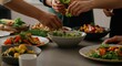 © Alexandr - People gathered around a table assembling colorful salads for a shared meal