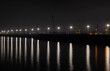 © sebi_2569 - Constanta - Romania seaport at night with cranes and lights reflected in the sea water