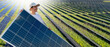 © scharfsinn86 - Woman wearing white cap and t-shirt holds solar panel.