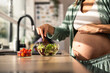 © milanmarkovic78 - Pregnant Woman Preparing Salad
