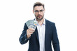 © Volodymyr - Good payment. Handsome business man holding money isolated over grey studio. Money in dollar banknotes. Pile of cash, finance, investment and money saving.