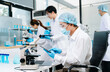 © Nuttapong punna - A scientific team working together in a modern laboratory, testing samples, mixing liquids, analyzing data, and using advanced lab equipment