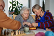 © Halfpoint - Group of senior people enjoying different activities in community center.