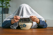 © Maren Winter - Cold and flu season in fall and winter, elderly man with a towel over his head inhaling hot herbal steam over a bowl, health concept, copy space