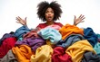 © Penelope - Shocked woman with curly Afro hair stares bugged eyes drowned in huge pile of colorful clothing cleans out closet selects clothes for donation or recycling white background. Housework concept