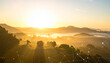 © LuckyStride - 朝日と霧に包まれた山々にネットワーク線が走る自然とデジタルの融合背景