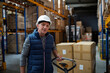 © Halfpoint - Older male warehouse worker pulling a pallet truck.