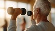 © filmanana - senior fitness strength training workout — determined older man lifting dumbbells in warm sunlight, clean minimal style, wellness motivation visual for healthcare and active aging