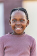 © poco_bw - Village African child girl with dreadlocks in front of the house, at sunset, standing in the yard