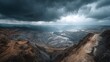 © horizon - Dramatic, wide-angle aerial shot of a vast open-pit mine. The terraced levels and industrial infrastructure are seen under a moody, overcast sky.