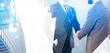 © ImageFlow - Two people in business suits shaking hands, double exposure style with tall buildings, on a bright background, concept of agreement and partnership