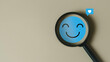 © The KonG - Mental health and customer satisfaction survey concept with magnifying glass focusing on a smiling face emoji. Ideal for wellness check-ins, feedback systems, and emotional experience insights.
