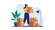 © Rafiya1727 - Woman holding moving boxes in a room with houseplants and a floor lamp.