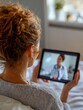 © Johannes - back view of woman making video call with her doctor while staying at home close up of patient in video conferencing with general practitioner on digital tablet sick girl in online consultation no lo
