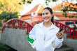 © Ranta Images - Young Asian Woman in Sporty Casual Outfit Outdoors in Traditional Garden