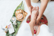 © InfiniteFlow - Woman indulges in blissful foot massage at luxurious spa salon while masseur give reflexology therapy in gentle day light ambiance resort or hotel foot spa. Quiescent